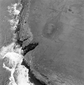 Oblique aerial view centred on the chambered cairn (south) on Holm of Papa Westray.