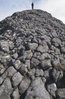 Eigg, An Sgurr, Fort. View of Alex Hale at summit.