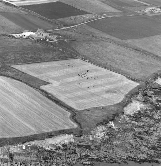 Oblique aerial view centred on the remains of Broch of Burgar with the Burgar farmsteading visible in the background.