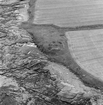 Oblique aerial view centred on the remains of Broch of Burgar.