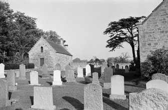 General view of the tithe barn and churchyard, Foulden, from W.
