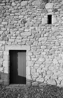 Detail of tithe barn, Foulden, showing stonework and door to rear.