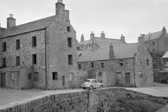 General view of buildings in Shorehead, Portsoy, including 24-26 North High Street and 31 Low Street.