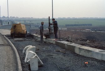 M8, Monklands Motorway, Easterhouse Road Motorway Bridge
One 35mm colour negative.
Frame 2: Detail of work erecting safety barriers to bridge.