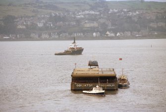 Dumbarton, Castle Road, William Denny and Sons Ltd
Frame 27: General views of mitre gates for Gladstone Dock, Liverpool, having been loaded onto Goliat21 at the former shipyard of William Denny and Brothers Ltd, entering the Firth of Clyde.