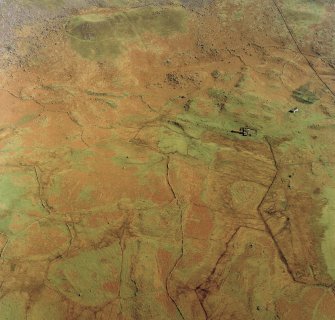 Oblique aerial view centred on the remains of the township and field-system with farmstead adjacent, taken from the W.