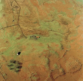 Oblique aerial view centred on the remains of the township and field-system with farmstead adjacent, taken from the E.