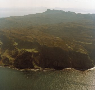 General oblique aerial view of the west side of Eigg with the fort in the foreground and the Sgurr fort beyond, taken from the NNW.