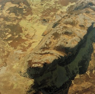 Oblique aerial view centred on the E end of An Sgurr and the remains of the fort, taken from the NE.