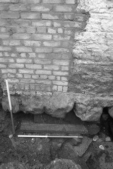 Jedburgh Abbey excavation archive 1985
Frame 5: Ashlar masonry belonging to the abbey's reredorter lying below the W wall of No.4 Abbey Bridge End. From W.

