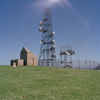 View of telecommunications mast and dovecot from W