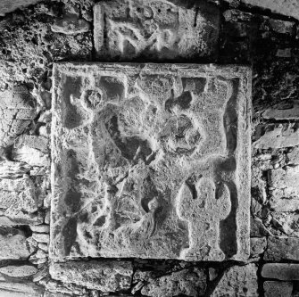  View of tomb recess in N wall showing detail of ornamental panel, St Donnan's Church, Kildonnan, Eigg.