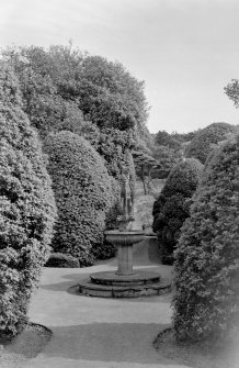 View of fountain and surrounding shrubbery in garden of Ravelston House, Edinburgh.