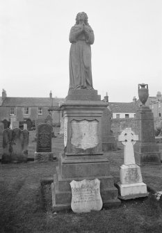 View of gravestone with statue commemorating James Anderson Hughes, 1865, in the churchyard of Pittenweem Parish Church.