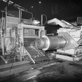 Interior.
View of recoiling of steel strip at end of inspection line and stretch level.