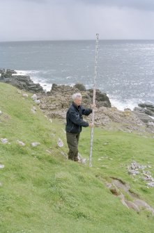 Muck, Caisteal an Duin Bhain. Fort. Site survey in progess. Steve Boyle with the staff.