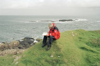 Muck, Caisteal an Duin Bhain. Fort. Site survey in progess. Ian Parker with the drawing board.