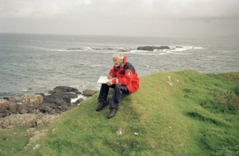 Muck, Caisteal an Duin Bhain. Fort. Site survey in progess. Ian Parker with the drawing board.