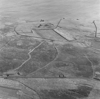 Oblique aerial view centred on the remains of the broch at Dalsetter.