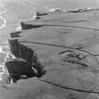 Oblique aerial view centred on the remains of the broch at Dalsetter.