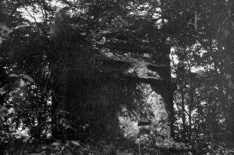 View of entrance elevation of St Colme House dovecot, Aberdour, through trees.
