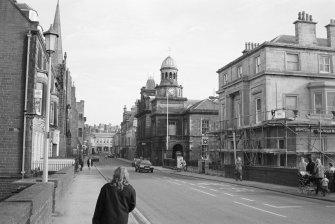 View of Bridge Street, Wick, showing the Royal Bank of Scotland building (with scaffolding), Town Hall and Sheriff Court House.
