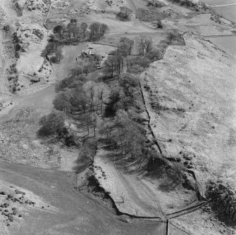 General oblique aerial view centred on the remains of St Blane's Church and burial ground, Bute, taken from the NNW .