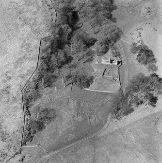 Oblique aerial view centred on the remains of St Blane's Church and burial ground, Bute, taken from the S.