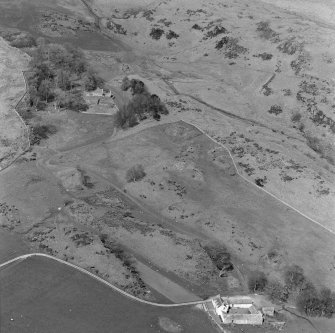 General oblique aerial view centred on the remains of St Blane's Church and burial ground, Bute, taken from the SSE.