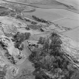 General oblique aerial view centred on the remains of St Blane's Church and burial ground, Bute, taken from the N.