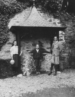 Photographic copy of view of 3 children standing near decorative shelter in garden.
PHOTOGRAPH ALBUM NO: 21  : CYCLE TOUR ALBUM