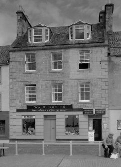 View of 29-30 Shore Street, Anstruther Easter, from SW, showing a grocer and wine merchant and a photographer studio.