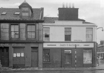 View of 2-4 Glasgow Street, Ardrossan, from NW, showing James R MacGregor, dispensing chemist.