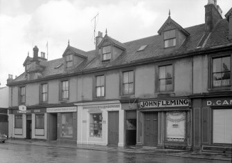 View of 10-18 Glasgow Street, Ardrossan, from NW, showing the premises of The Horse Shoe, City of Glasgow Friendly Society, A Cunningham & Son ironmongery and hardware shop, and John Fleming.