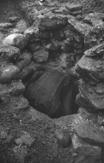 Excavation photograph:
View of man in well at excavation in High Street, Arbroath

