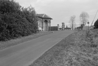 View from drive showing lodge porch and gates.