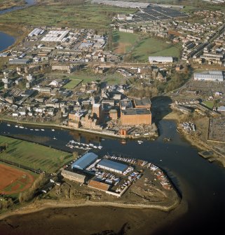 Oblique aerial view centred on the boat yard and whisky distillery, taken from the SSW.