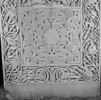 Detail of the spirals panel and vine scroll border on the modern reconstruction sculpture by Barry Groves, representing face C of the cross-slab found at Hilton of Cadboll. The modern version stands close to the chapel site.
 

