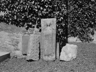 Churchyard, a small stone decorated with a robed figure, and fragments of two hog-backed stones