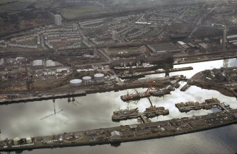 Oblique aerial view of the Great Harbour and James Watt Dock, taken from the NE.