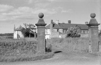 View of gatepiers, W gates, N and S lodges and Letham House from SW.