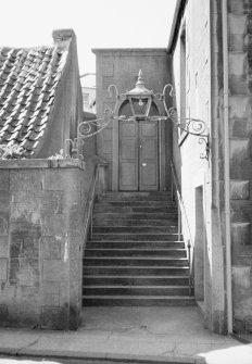 View from E of stairs up to entrance doorway.