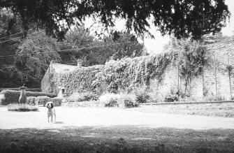 General view from E showing sundial and dwarf walls of demolished glasshouses.