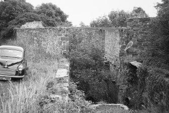 View of mill race and buildings.