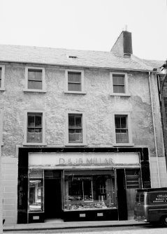 View of half of street facade. Includes shop facade of 'D. & J.B. Millar'