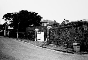 View from south west of wall enclosing Cardy Net Works with Cardy Cottage and Cardy House in the background