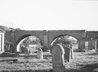 View of arches with gravestones in foreground