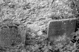 General view of remains of church wall and gravestones