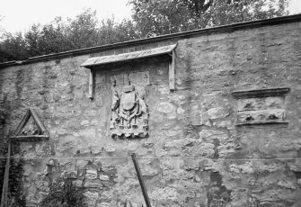 Detail of S terrace wall showing carved coat of arms.
