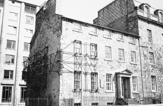 View of No. 14 seen from the South West. A scaffolding structure is present on the West side of the building where No. 15 once adjoined which stretches to the front facade and covers four windows. The University Medical School is visible in the background.